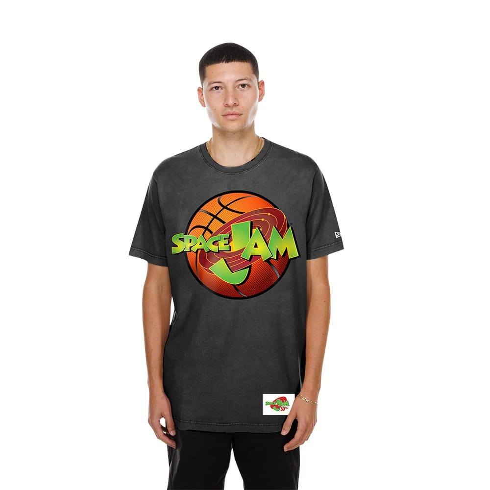 New Era Space Jam Warner Brothers Space Jam Black T-Shirt, front view on-model showing a large basketball graphic with bright green Space Jam lettering across the chest and a small embroidered New Era logo on the left sleeve.