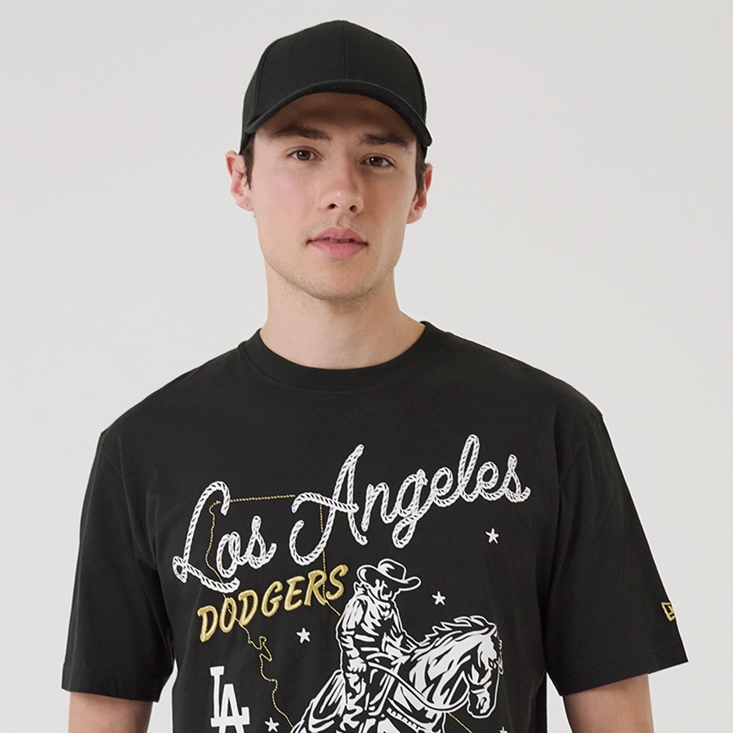 The model is wearing this MLB Cowboy Graphic LA Dodgers T-Shirt in black. 7