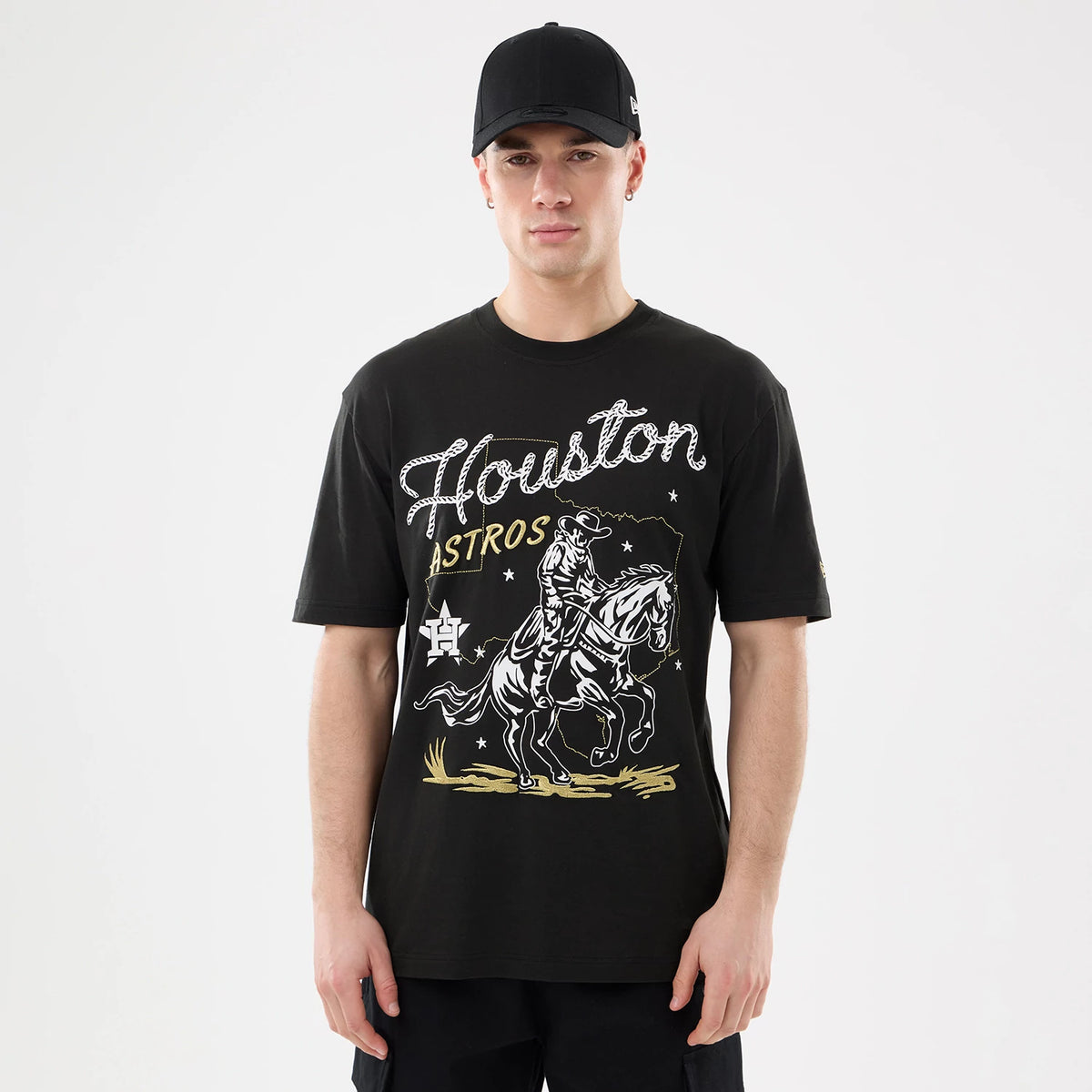 New Era Houston Astros MLB Cowboy Graphic Black T-Shirt, front view on-model showing a large cowboy graphic and Houston Astros lettering in white across the chest, complemented by a embroidered logo on the sleeve.