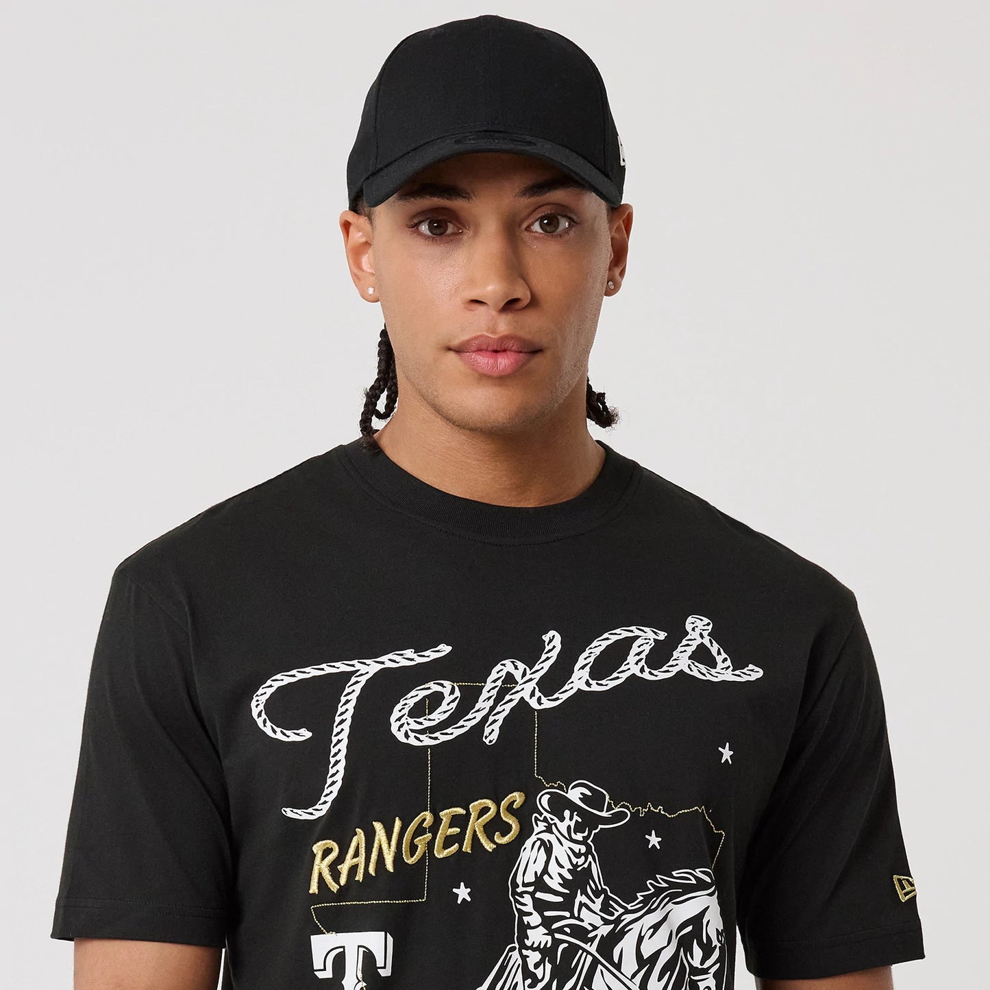 The model is wearing this MLB Cowboy Graphic Texas Rangers T-Shirt in black. 7