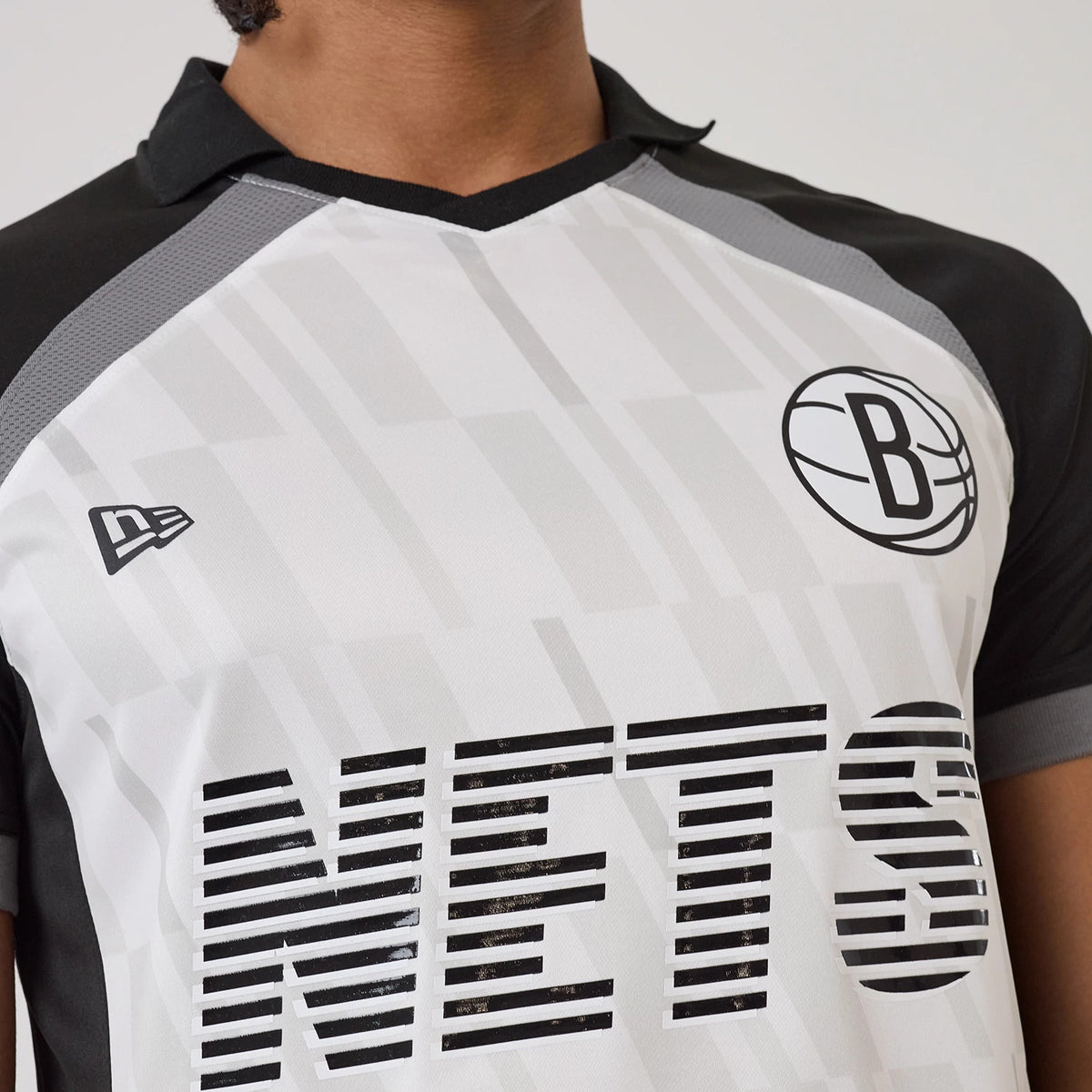 New Era Brooklyn Nets NBA Match Black T-Shirt, front view showing the black B basketball logo on the chest, striped NETS lettering below it, and an embroidered New Era flag logo on the left shoulder.