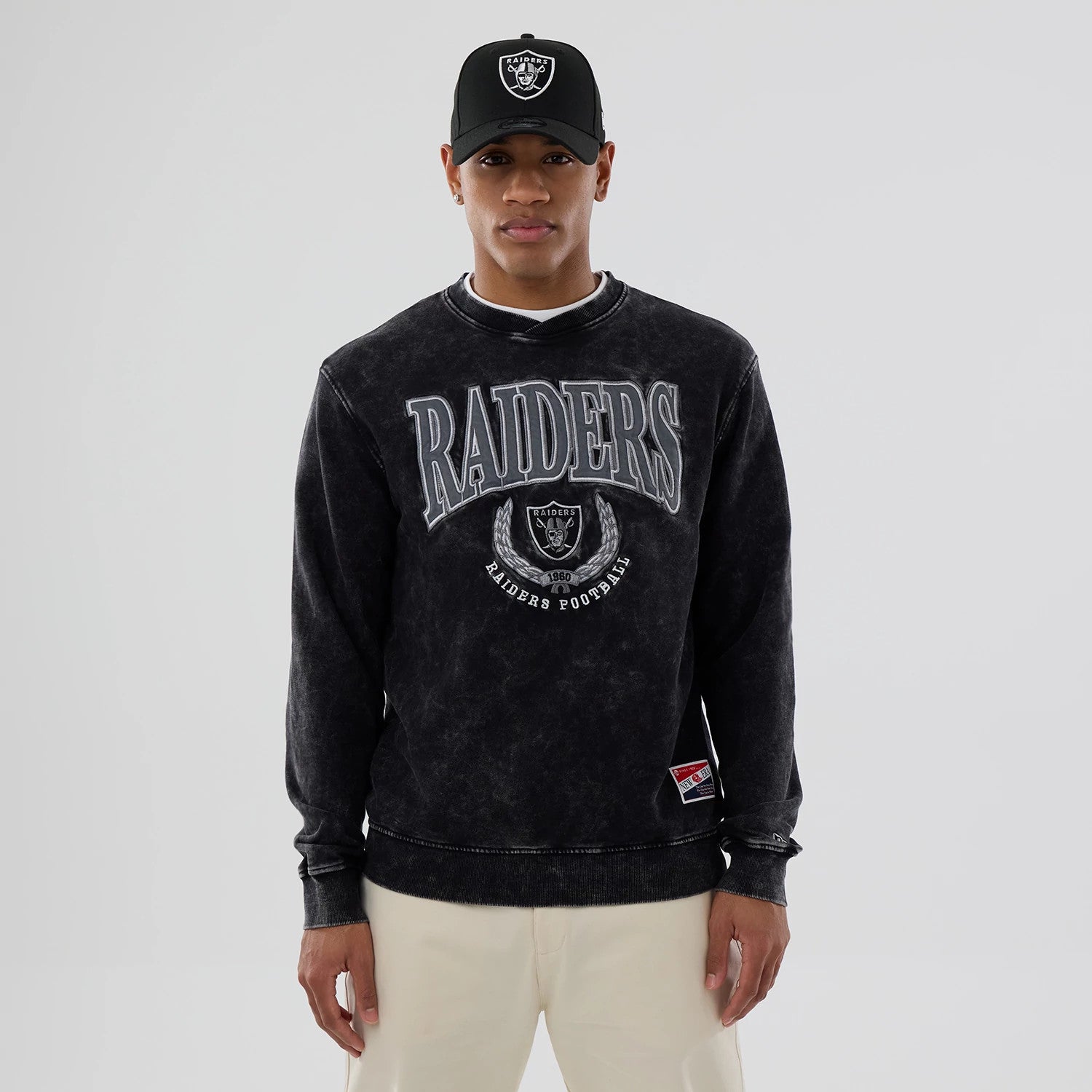 The model is wearing this NFL Las Vegas Raiders Laurel Wreath Crew Neck Sweater in black. 1