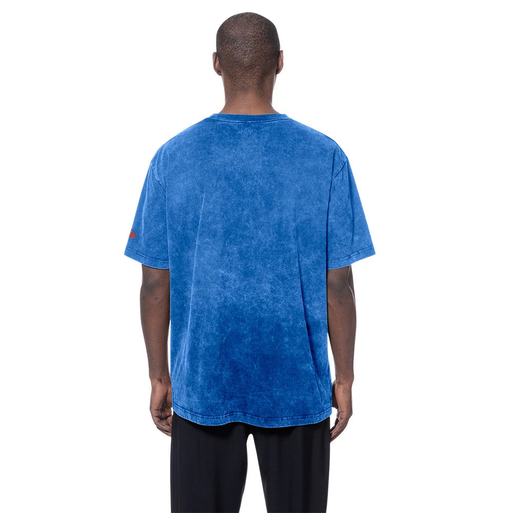 New Era Oklahoma City Thunder NBA Blue T-Shirt, back view on a model showing the saturated blue washed fabric with relaxed fit and short sleeves, and a small red embroidered New Era logo on the left sleeve.