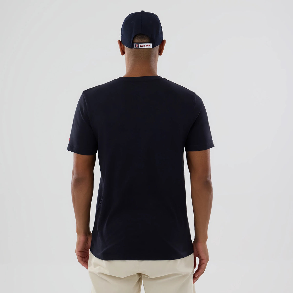 New Era Boston Red Sox MLB Popcorn Navy T-Shirt, back view on a model showcasing the plain navy back and short sleeves, paired with a matching navy cap displaying a printed RED SOX label on the rear.