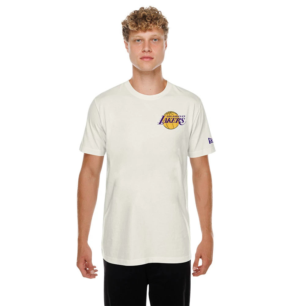 New Era LA Lakers NBA Hotdog Cream T-Shirt, front view on a model showing the Los Angeles Lakers logo with raised embroidery on the left chest and a small New Era flag on the left sleeve.