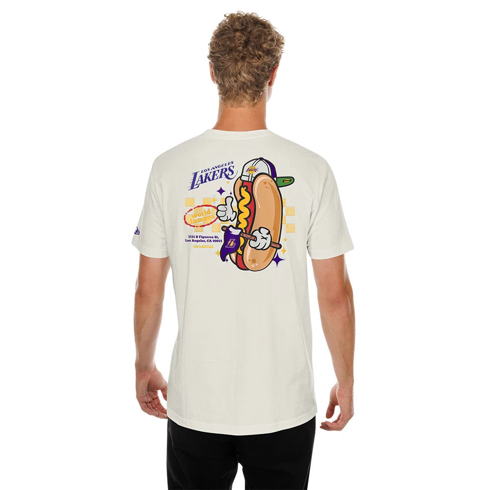 New Era LA Lakers NBA Hotdog Cream T-Shirt, back view on a model showing a playful graphic of a hotdog wearing a Lakers cap and gloves, with Los Angeles Lakers lettering above and team details below.