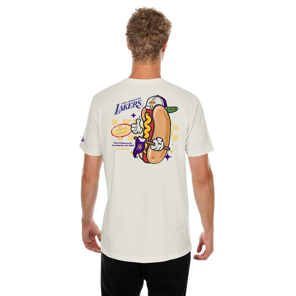 New Era LA Lakers NBA Hotdog Cream T-Shirt, back view on a model showing a playful graphic of a hotdog wearing a Lakers cap and gloves, with Los Angeles Lakers lettering above and team details below.