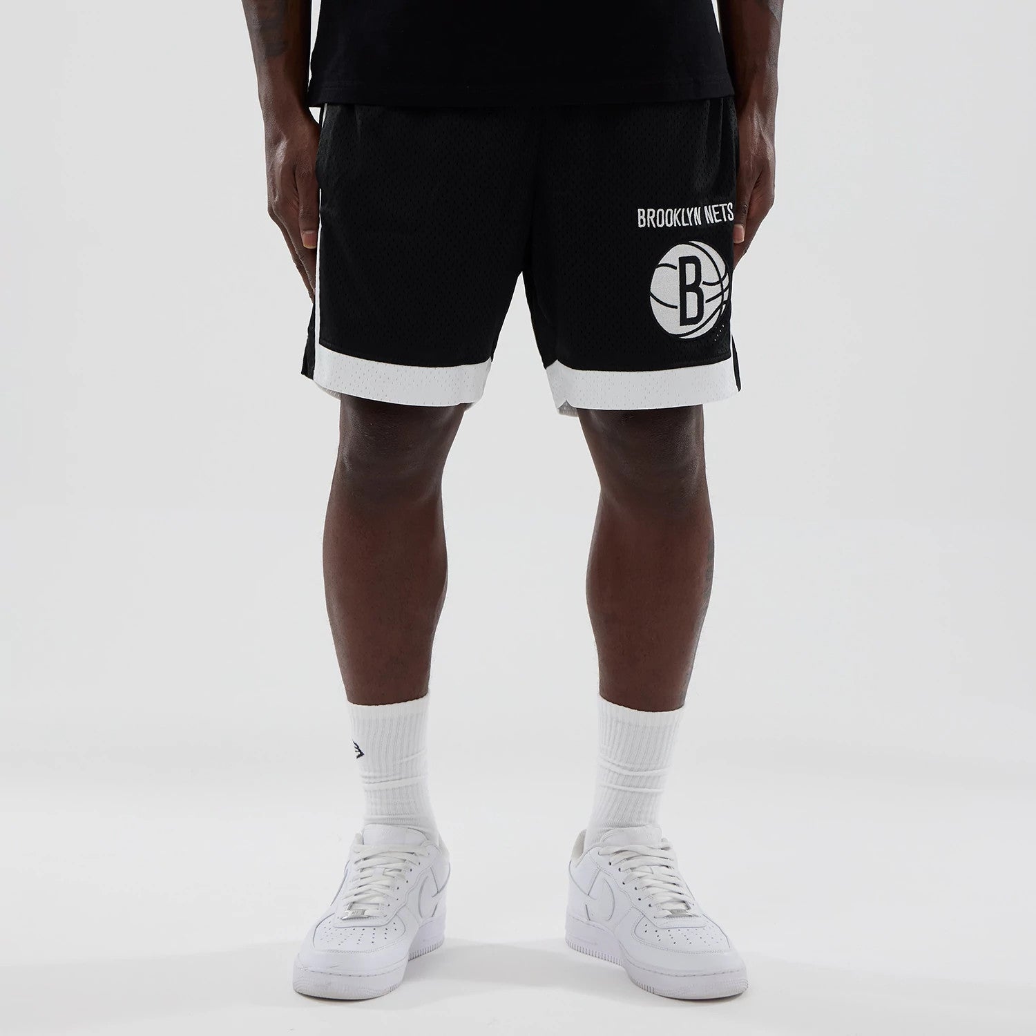 The model is wearing these NBA Brooklyn Nets Mesh Shorts in black. 1