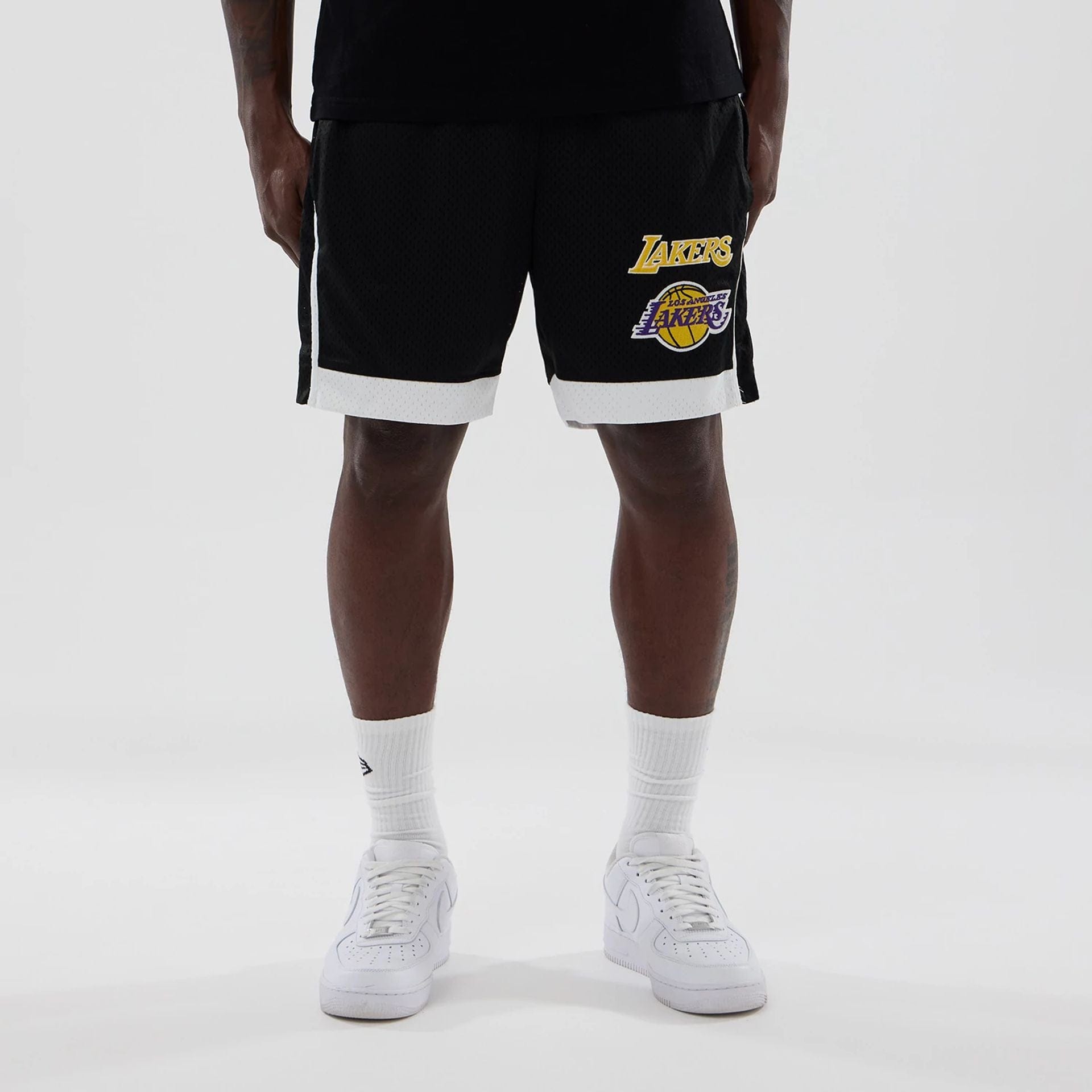 The model is wearing these NBA LA Lakers Mesh Shorts in black. 1