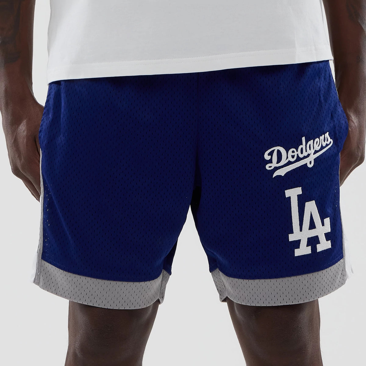 New Era LA Dodgers MLB Dark Blue Mesh Shorts, front view showing the white embroidered Dodgers script above the large LA logo on the left leg, contrasting grey trims at the hem, and mesh texture throughout.