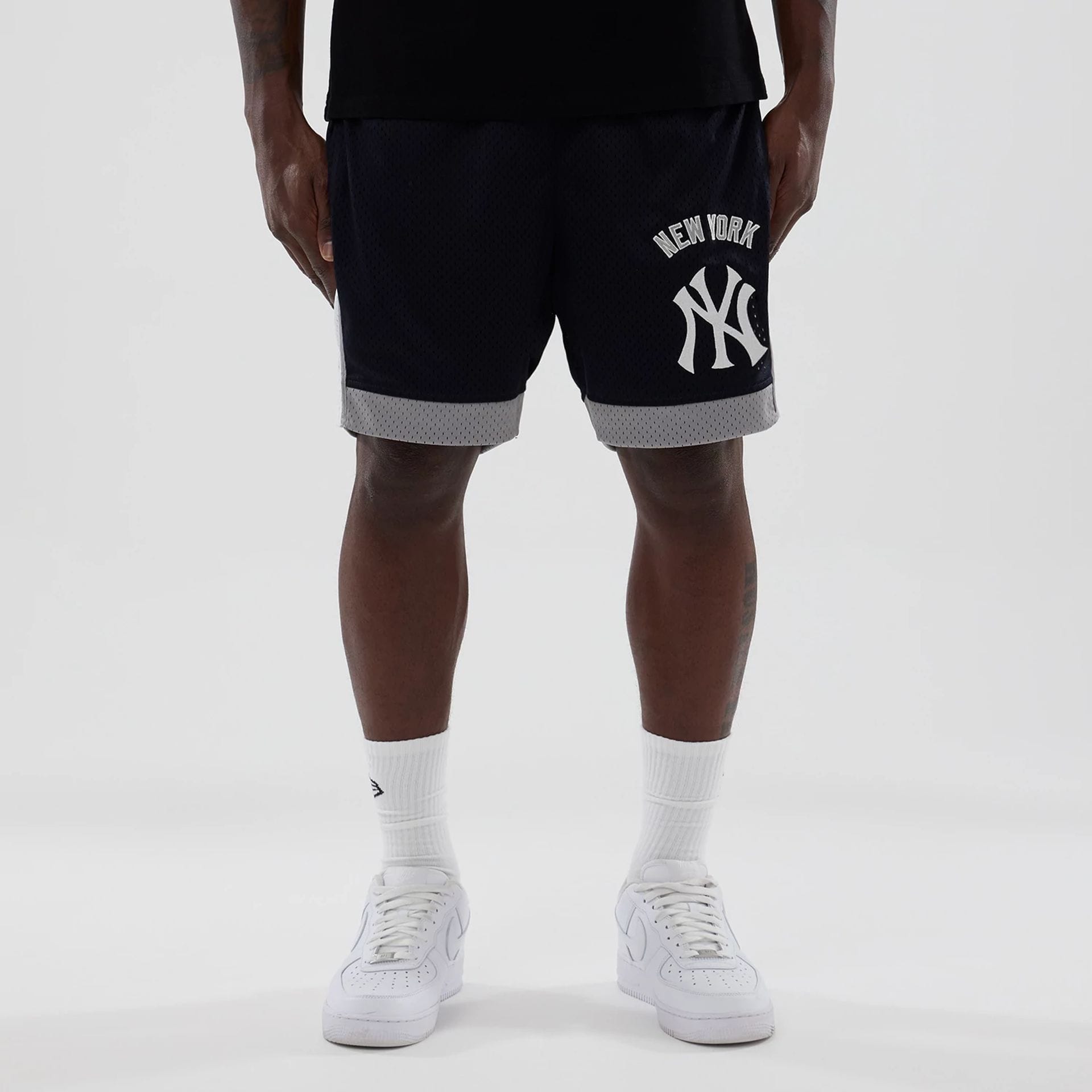 The model is wearing these MLB New York Yankees Mesh Shorts in navy. 1