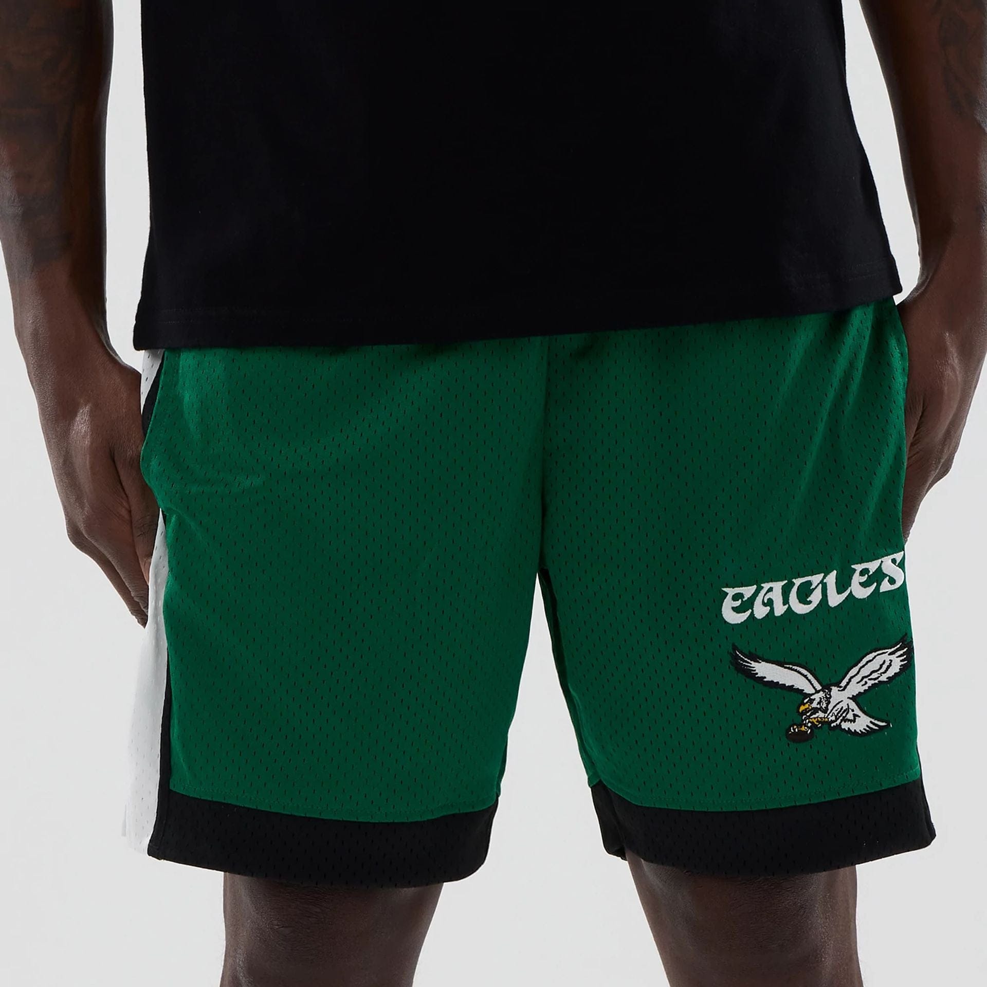 The model is wearing these NFL Philadelphia Eagles Mesh Shorts in green. 2