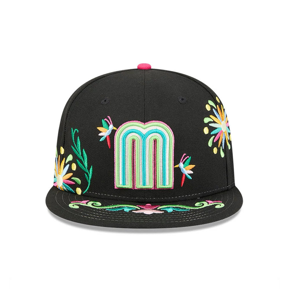 Mexico WBC Latin Embroidery Black New Era 59FIFTY Fitted Cap, front view showing the multicoloured embroidered M logo on the black crown, with floral patterns and hummingbirds on the panels and visor.