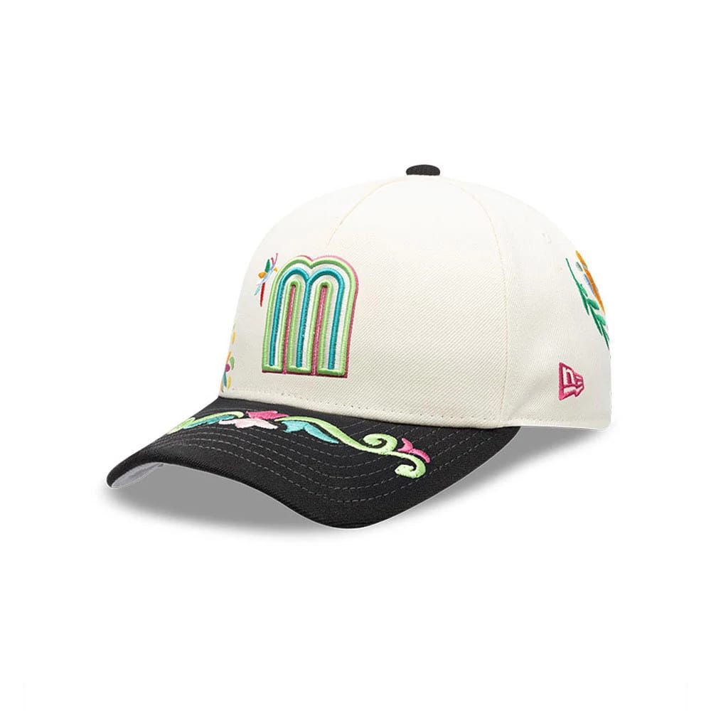 Mexico WBC Latin Embroidery White New Era 9FORTY M-Crown A-Frame Adjustable Cap, three-quarter view showing a colourful embroidered M on the front panel, with floral patterns on the black visor and a red New Era flag logo on the left side.