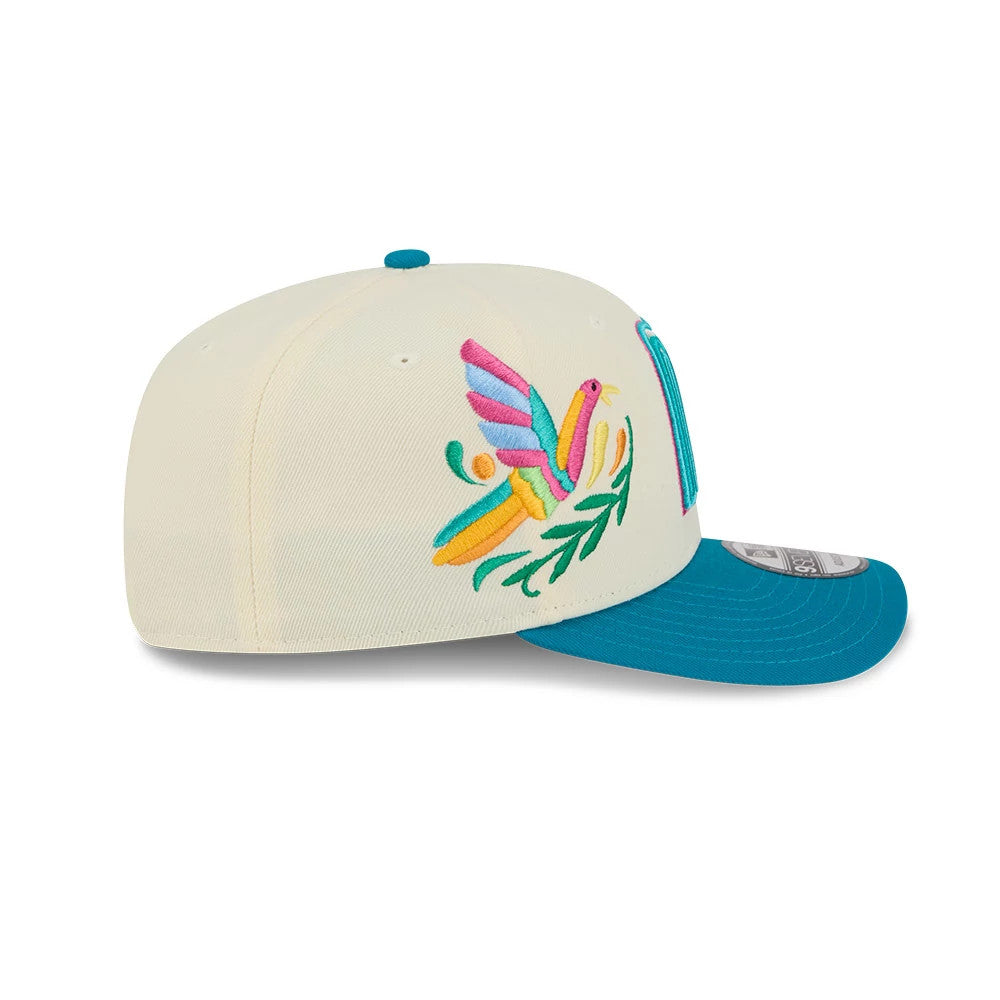 Mexico WBC Latin Embroidery White New Era 9SEVENTY Stretch Snap Adjustable Cap, side view with multicoloured bird embroidery on the white crown, turquoise visor, and New Era flag logo on the left side.