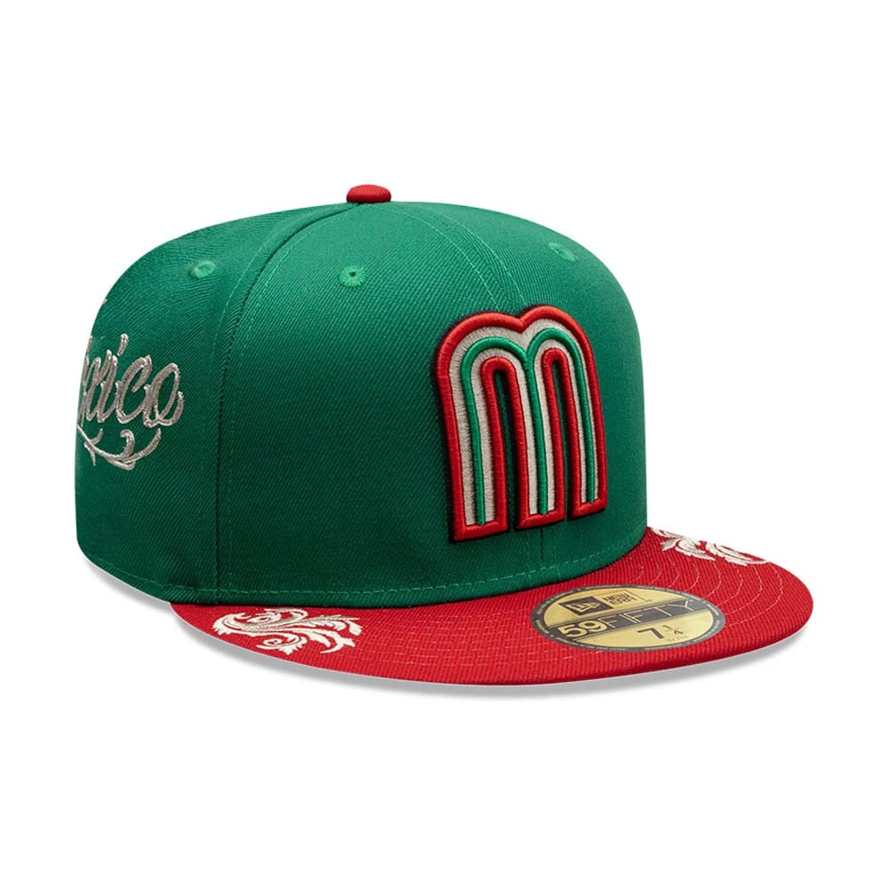 Mexico LMB Wordmark Green New Era 59FIFTY Fitted Cap, three-quarter view showing a raised red and green embroidered M on the front panel, red flat visor with white floral details, and a gold 59FIFTY size sticker.