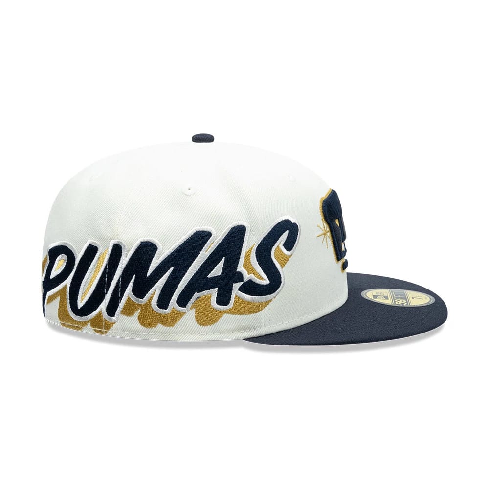 Pumas Unam Liga MX White New Era 59FIFTY Fitted Cap, side view showing large navy embroidered PUMAS lettering across the white crown, with a navy flat visor and gold 59FIFTY size sticker on top.