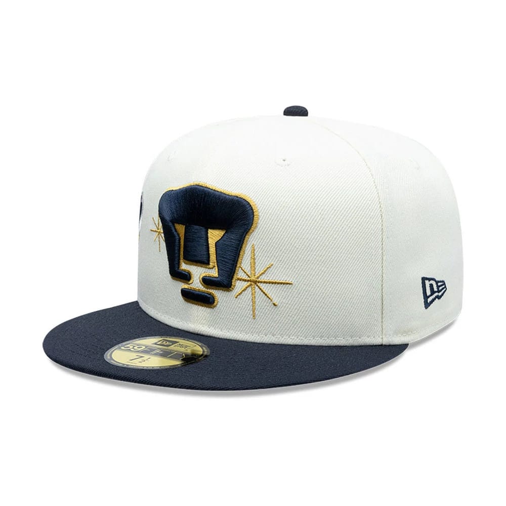 Pumas Unam Liga MX White New Era 59FIFTY Fitted Cap, three-quarter view showing the navy and gold embroidered front logo with star details, a navy flat visor and New Era flag logo on the left side, with a gold 59FIFTY size sticker.