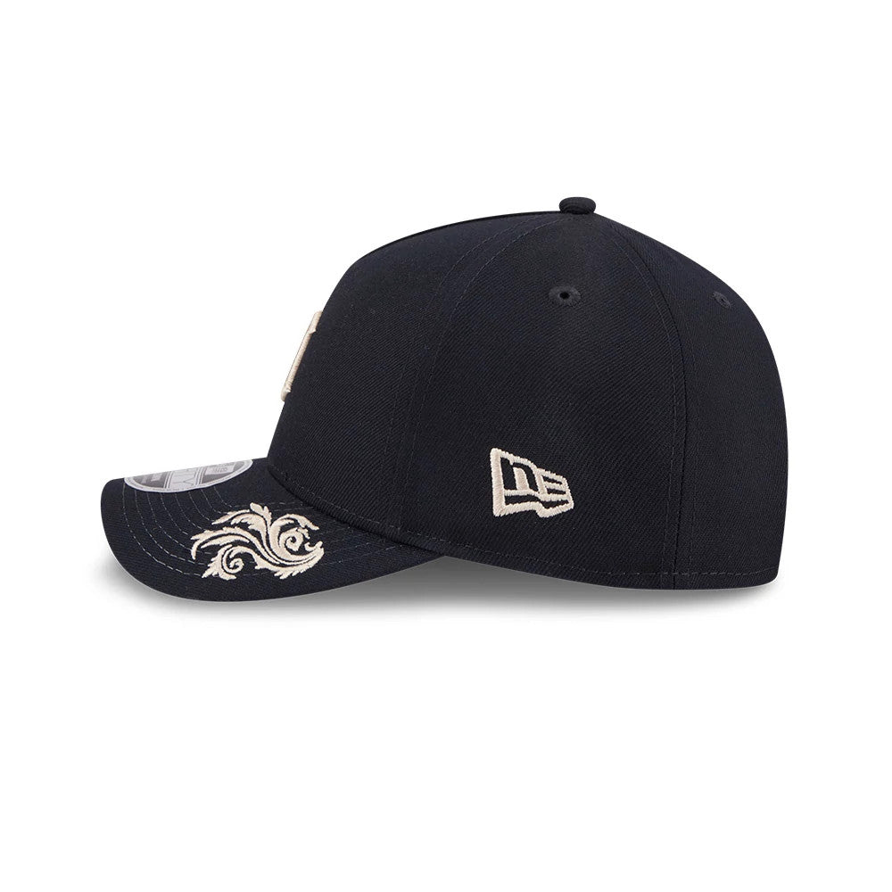 Detroit Tigers MLB Script Navy New Era 9FORTY M-Crown A-Frame Adjustable Cap, side view with cream embroidered New Era flag logo on the left side and intricate cream embroidery design on the black curved visor, plus a 9FORTY size sticker.