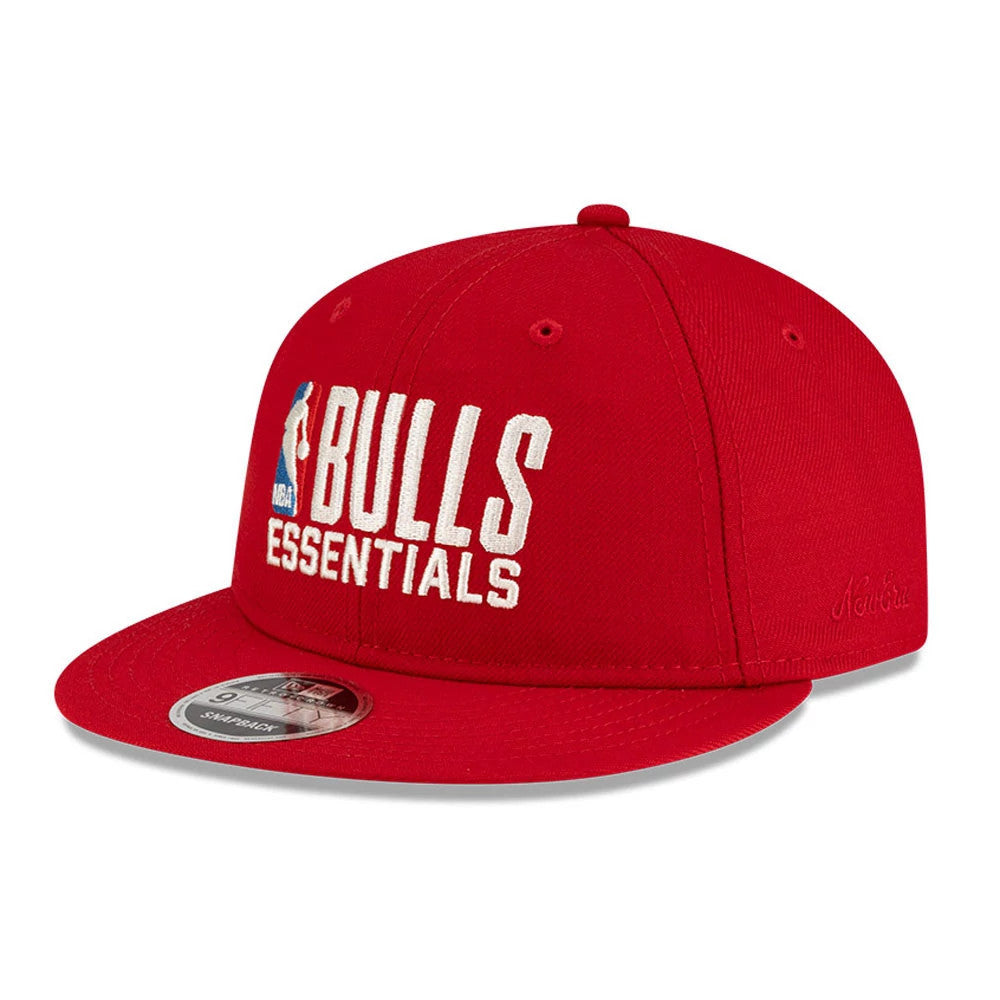 Chicago Bulls FOG x NBA Red Retro Crown New Era 9FIFTY Adjustable Cap, three-quarter view showing the white and blue embroidered Bulls Essentials logo on the front panels, with a flat red visor and a 9FIFTY size sticker.