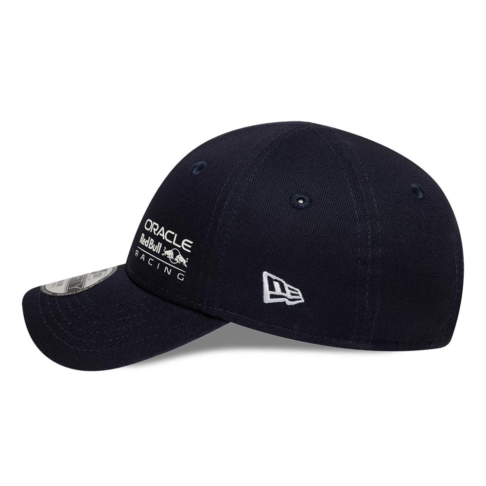 Red Bull Racing Toddler Navy New Era 9FORTY Adjustable Cap, side view showing the white embroidered New Era flag logo on the left side and a curved visor with a 9FORTY size sticker, under a structured navy crown.