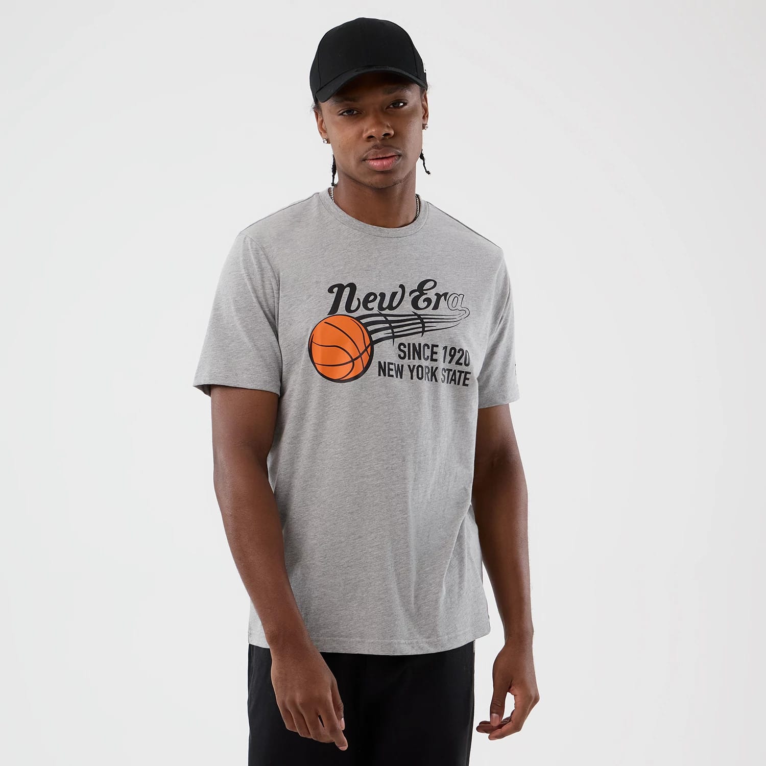 New Era Back To School Grey T-Shirt, front view on-model displaying a printed graphic of an orange basketball with text reading New Era Since 1920 New York State across the chest in black.