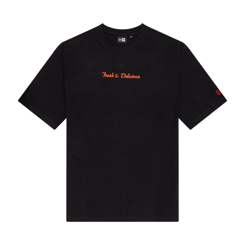 New Era Soy Sauce Graphic Black Oversized T-Shirt, front view showing the phrase Fresh & Delicious in orange text across the chest and a red embroidered New Era logo on the left sleeve.