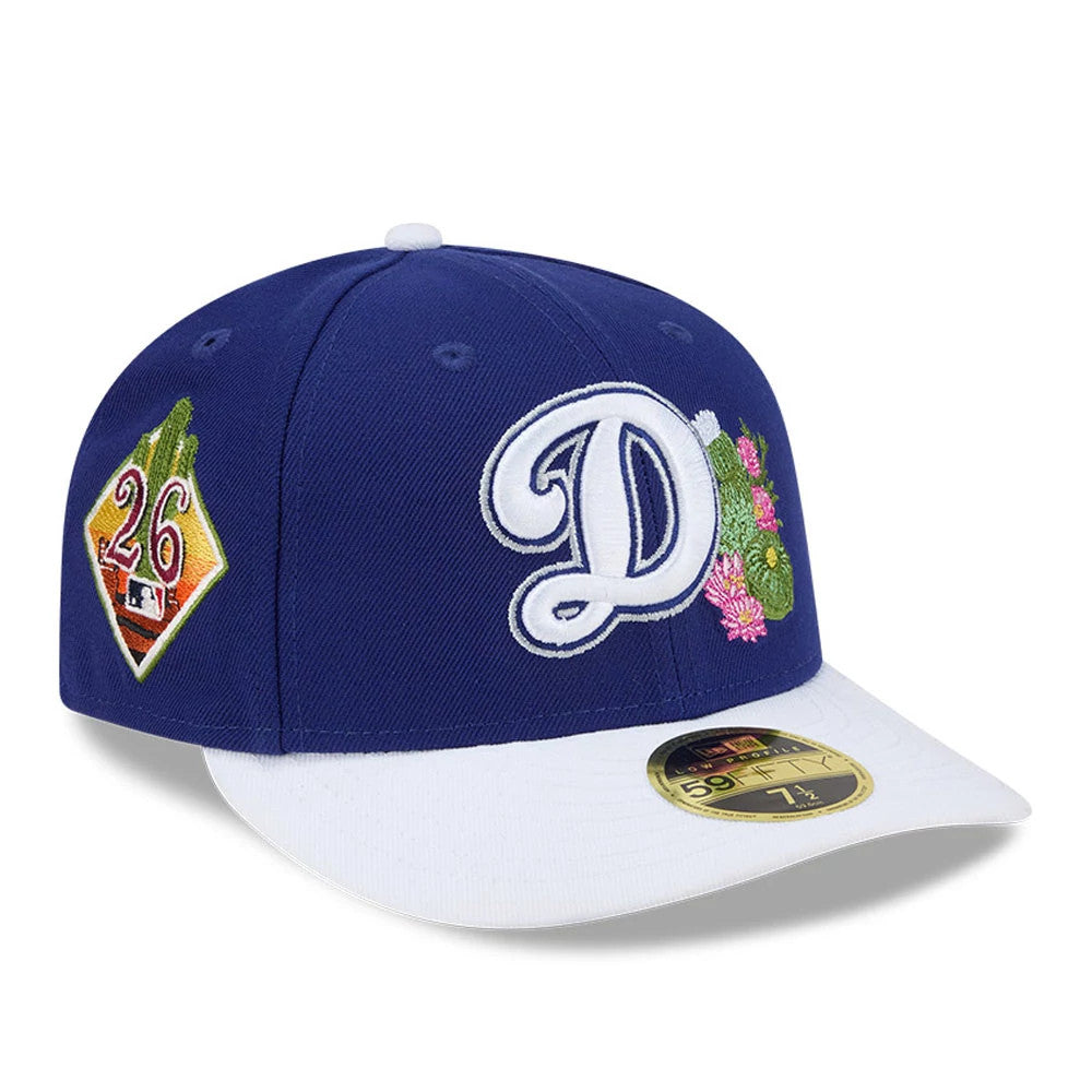 LA Dodgers MLB Spring Training 2026 Blue Low Profile New Era 59FIFTY Fitted Cap, three-quarter view with a large white embroidered D and cactus design on the front, team patch on the side, and a gold 59FIFTY size sticker on the flat white visor.