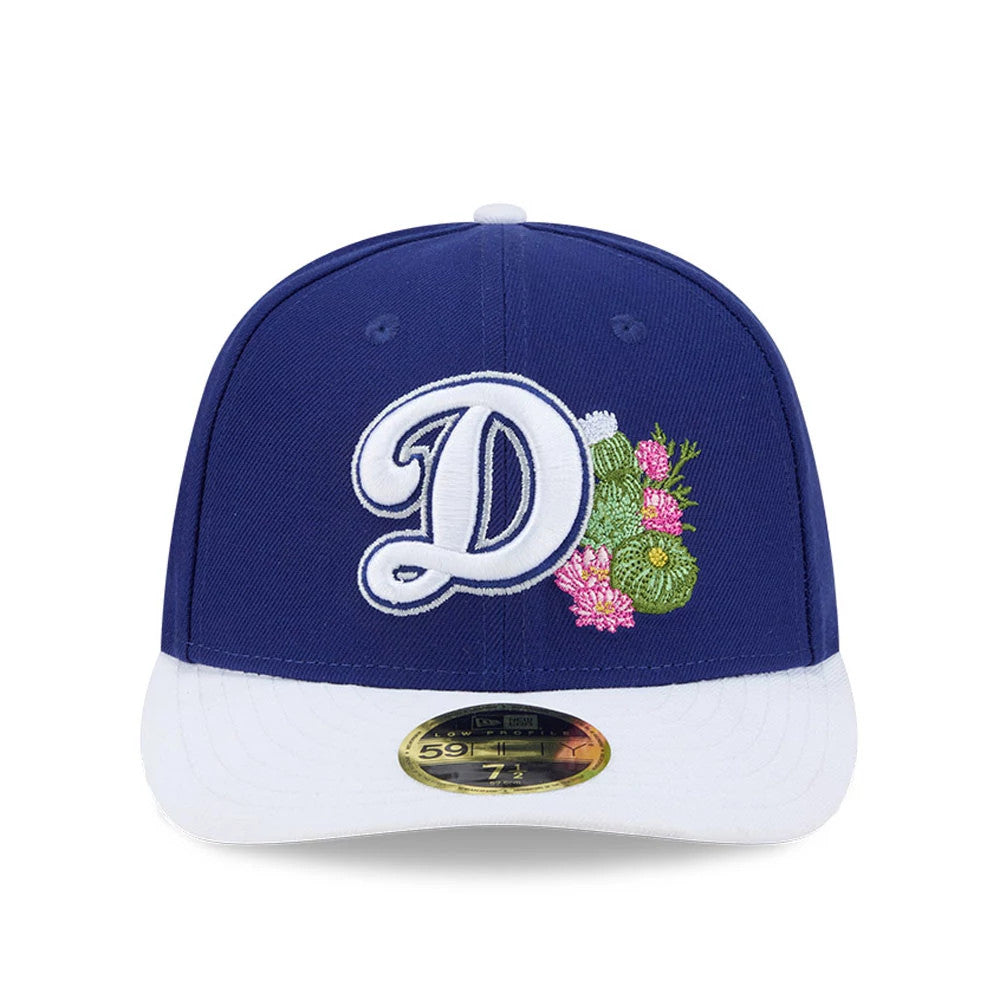 LA Dodgers MLB Spring Training 2026 Blue Low Profile New Era 59FIFTY Fitted Cap, front view showing a raised white embroidered D logo with green and pink floral design on the structured blue crown, with a white curved visor.