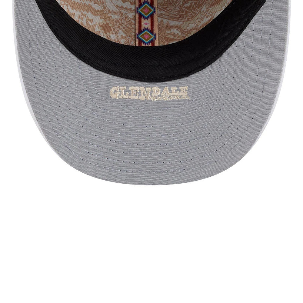 LA Dodgers MLB Spring Training 2026 Blue Low Profile New Era 59FIFTY Fitted Cap, inside view showing grey undervisor with 'Glendale' lettering, black sweatband, decorative taping with a geometric pattern, and printed interior panel design.