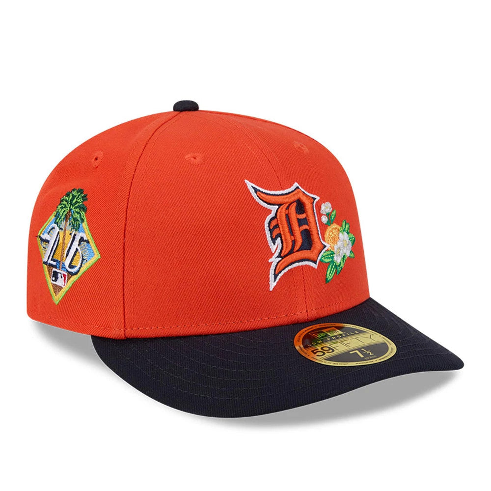 Detroit Tigers MLB Spring Training 2026 Red Low Profile New Era 59FIFTY Fitted Cap, three-quarter view with an orange embroidered D logo and flower on the front panel, side palm tree patch, navy visor and gold 59FIFTY size sticker.