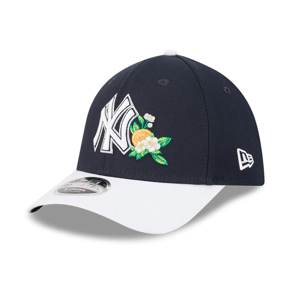 Yankees MLB Spring Training 2026 Navy New Era 39THIRTY M-Crown Stretch Fit Cap, three-quarter view showing raised white NY logo with orange and green floral embroidery, white curved visor with a 39THIRTY size sticker.