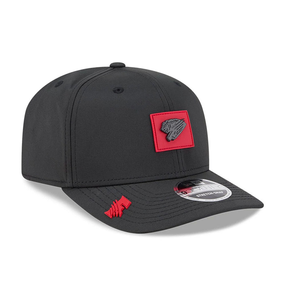 Fresno Grizzlies MiLB Clubhouse Black New Era 9SEVENTY Stretch Snap Adjustable Cap, three-quarter view showing a red Fresno Grizzlies logo patch on the front panel, black curved visor with a red logo, and a 9SEVENTY size sticker.