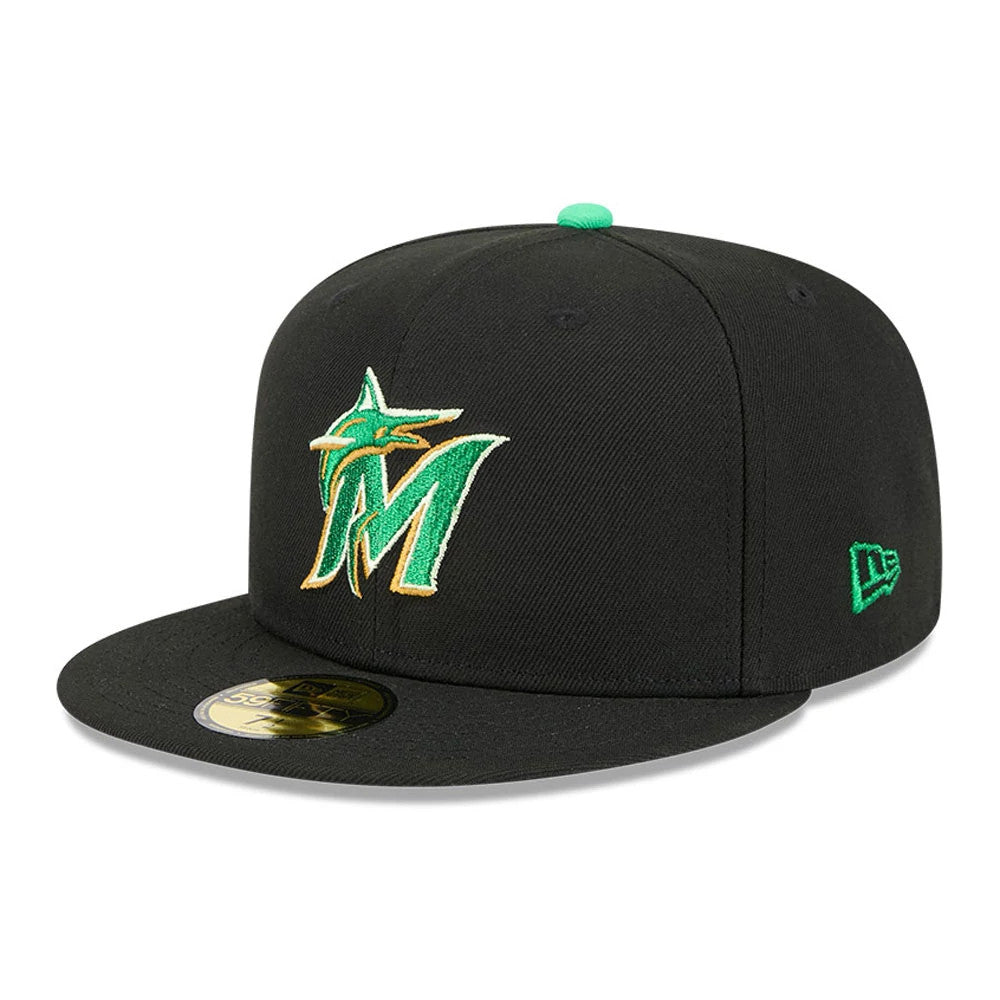 Miami Marlins MLB Saint Patrick's Day Black New Era 59FIFTY Fitted Cap, three-quarter view showing a green and gold raised embroidered team logo on the front panel, black visor with a gold 59FIFTY size sticker.