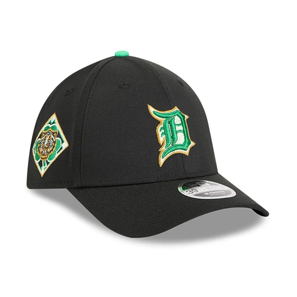 Tigers MLB Saint Patrick's Day Black New Era 39THIRTY M-Crown A-Frame Stretch Fit Cap, three-quarter view showing the green and gold embroidered D logo on the front panel, black curved visor with 39THIRTY size sticker, and green top button.