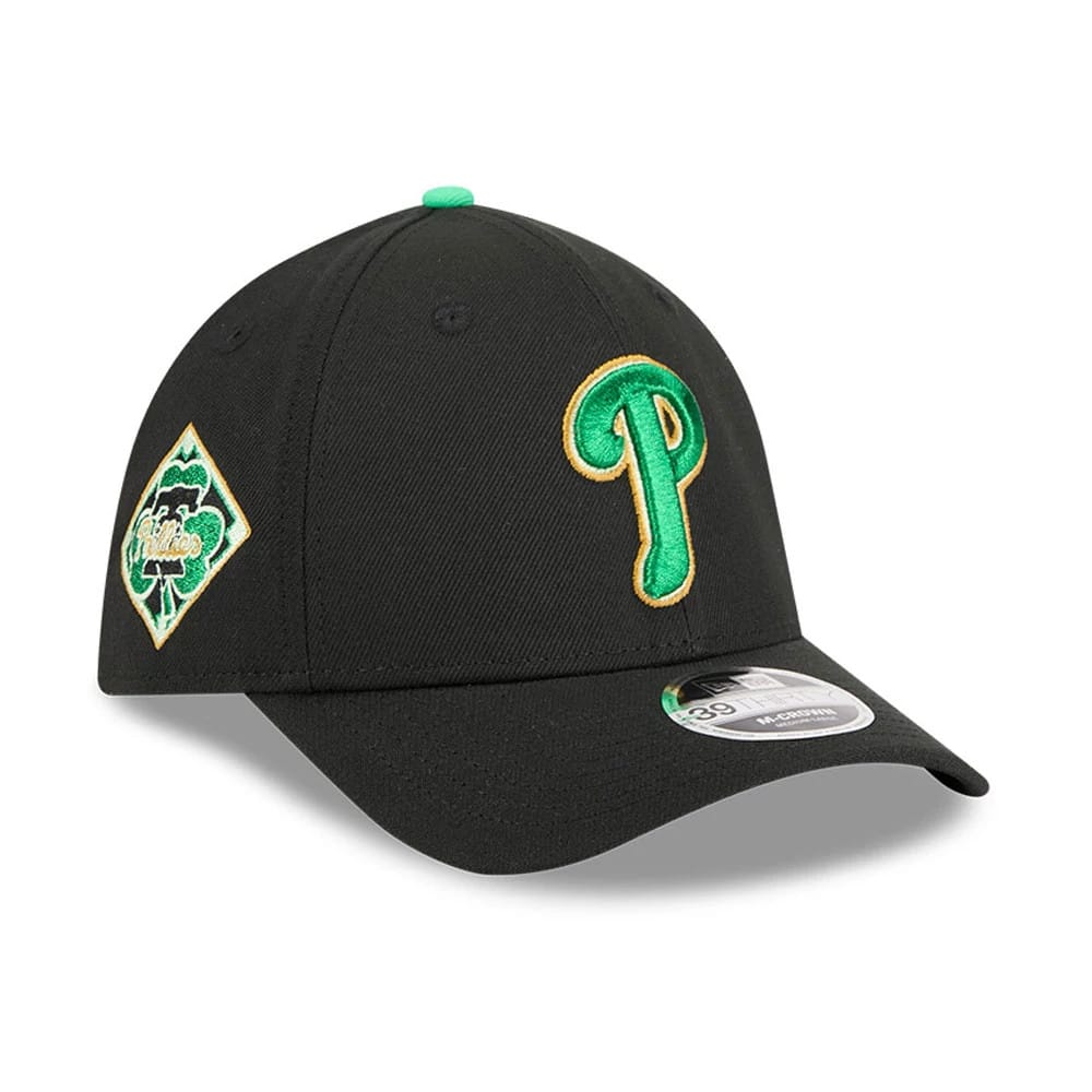 Phillies MLB Saint Patrick's Day Black New Era 39THIRTY M-Crown A-Frame Stretch Fit Cap, three-quarter view showing a green and gold embroidered Phillies logo on the front panel, a shamrock side patch.