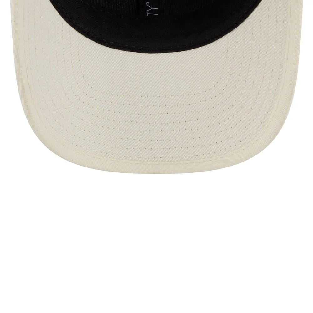 New York Yankees MLB Wicker Cream New Era 9SEVENTY Stretch Snap Adjustable Cap, inside view showing the black sweatband with branded taping and the cream undervisor, highlighting the contrasting design elements.