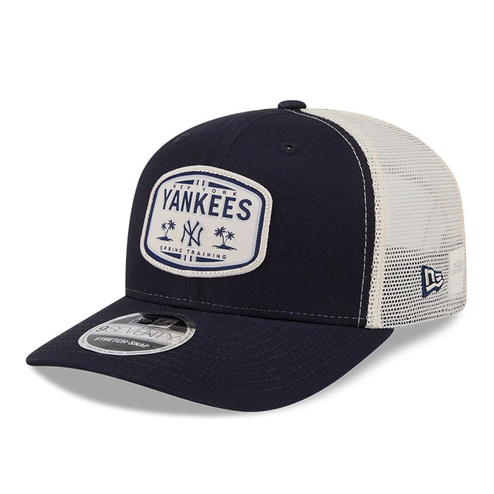 New York Yankees MLB Patch Navy New Era 9SEVENTY Stretch Snap Adjustable Cap, three-quarter view showing a white embroidered patch with navy lettering on the front panel and navy curved visor with a 9SEVENTY size sticker, and a white mesh back.