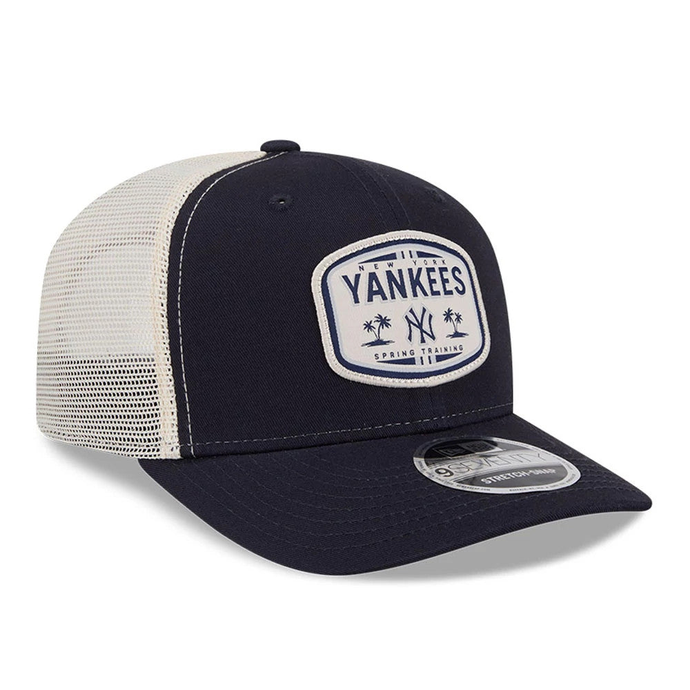 New York Yankees MLB Patch Navy New Era 9SEVENTY Stretch Snap Adjustable Cap, three-quarter view showing a raised embroidered Yankees logo patch on the front panel, with a curved navy visor and a white mesh back, featuring the 9SEVENTY size sticker.
