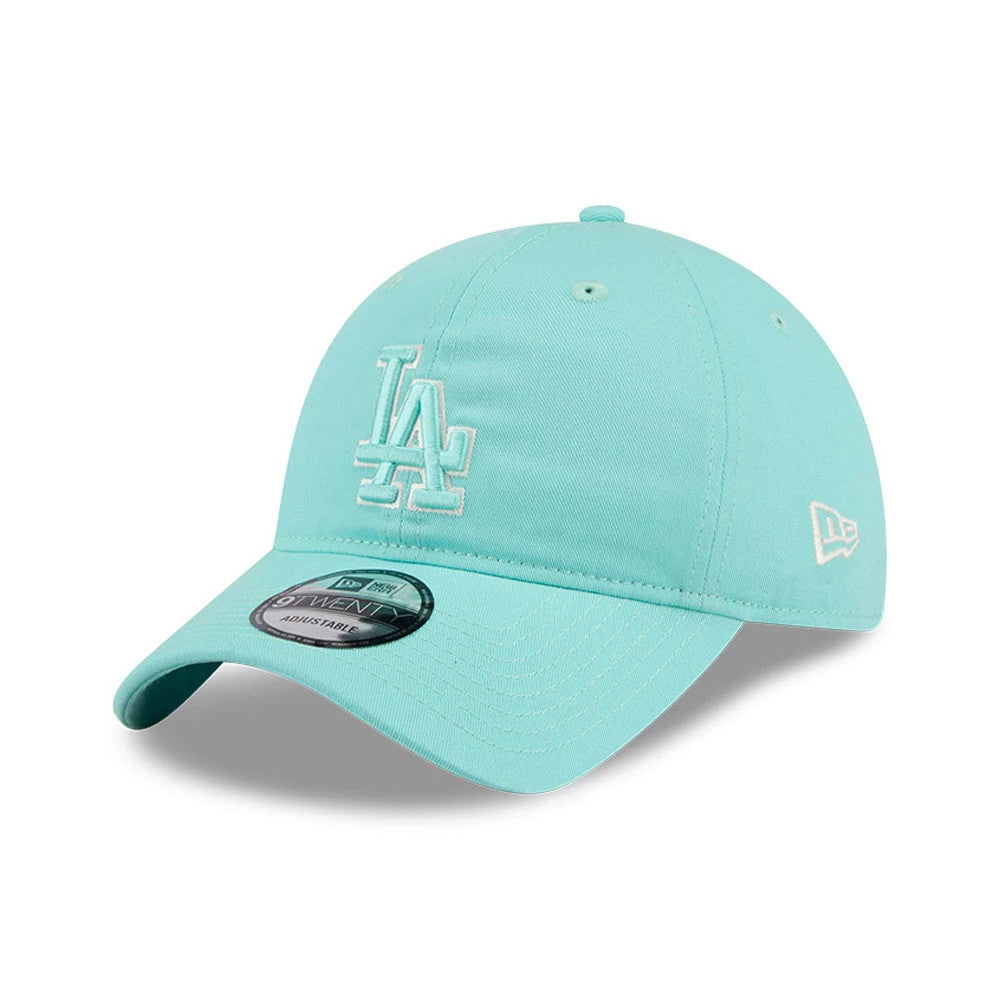 LA Dodgers MLB Colours Turquoise New Era 9TWENTY Adjustable Cap, three-quarter view showing the white embroidered LA logo on the front panel, curved turquoise visor with 9TWENTY size sticker, and New Era flag logo on the left side.