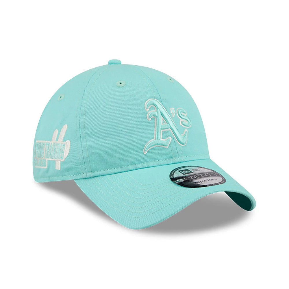 Athletics MLB Colours Turquoise New Era 9TWENTY Adjustable Cap, three-quarter view showing the white raised embroidery A's logo on the front panel, turquoise curved visor with a black 9TWENTY size sticker, and side spring training graphics.