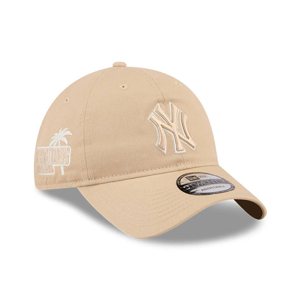 New York Yankees MLB Colours Light Beige New Era 9TWENTY Adjustable Cap, three-quarter view showing a raised white Yankees logo on the front panel, a palm tree graphic with text on the side, a curved visor and a 9TWENTY size sticker.