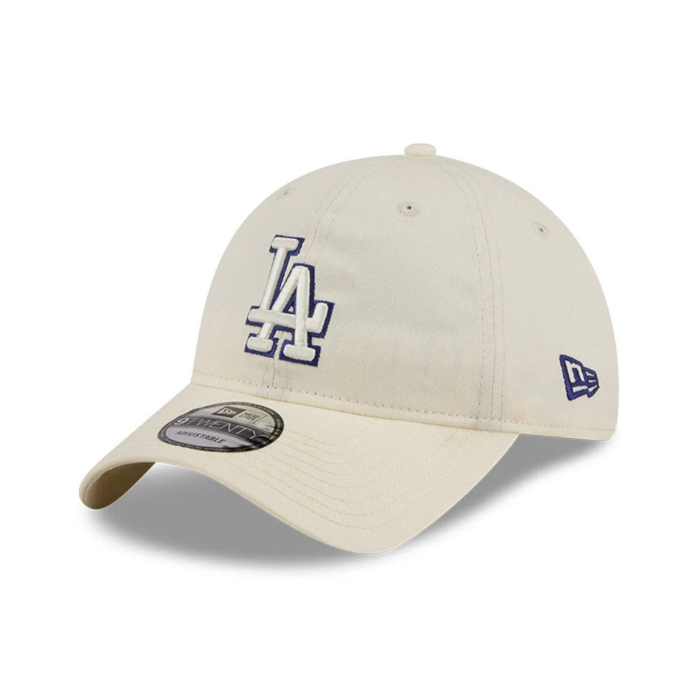 LA Dodgers MLB Colours White New Era 9TWENTY Adjustable Cap, three-quarter view showing the blue LA logo in raised embroidery on the front panel and the New Era flag logo in blue on the left side, with a curved visor and 9TWENTY size sticker.