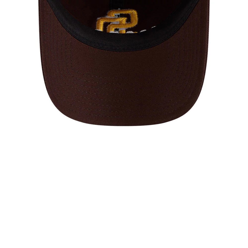 San Diego Padres MLB Colours Dark Brown New Era 9TWENTY Adjustable Cap, inside view showing a mustard yellow Padres SD logo partially under the brown bill, with a black sweatband lining the interior.