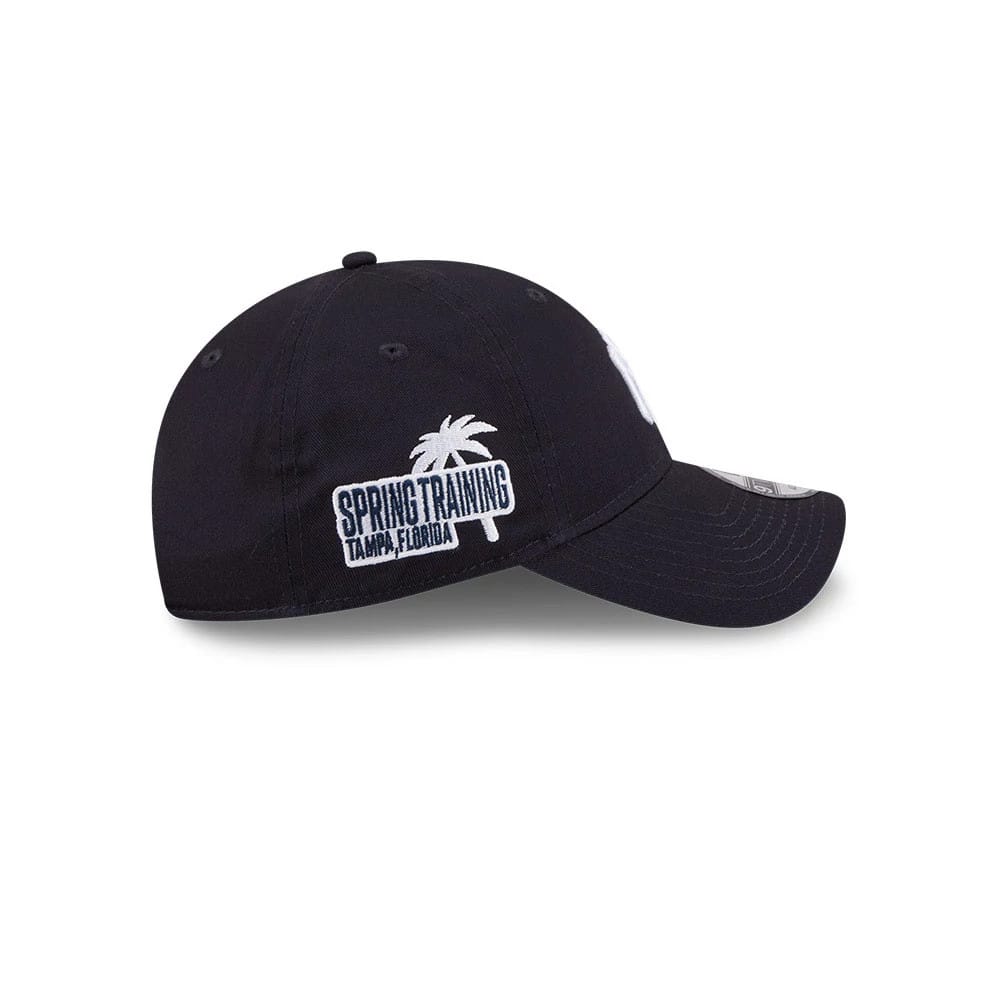 Yankees MLB Colours Navy New Era 9TWENTY Adjustable Cap, side view showing a white embroidered Spring Training Tampa, Florida graphic on the lower left panel, navy curved visor, and grey 9TWENTY size sticker.