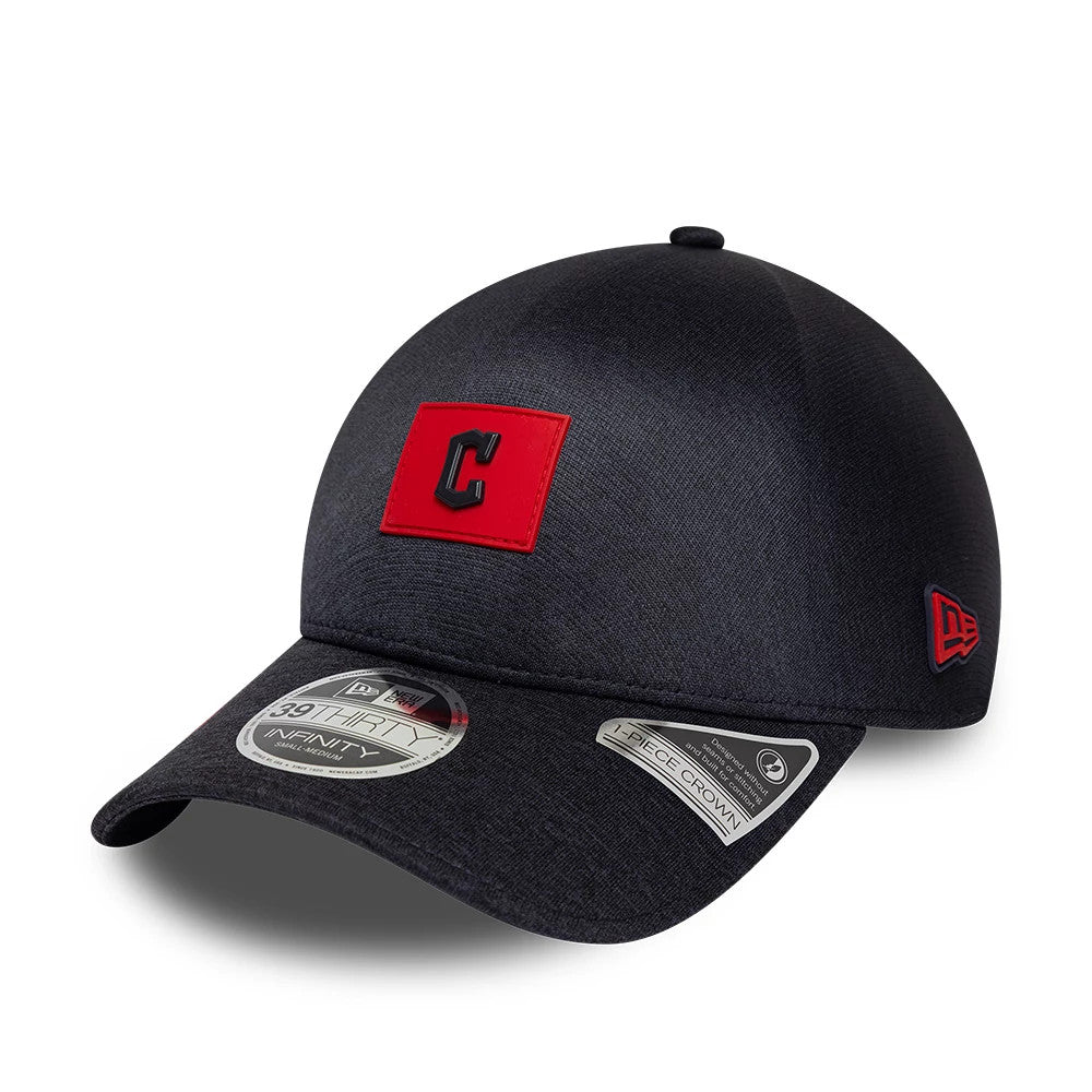 Cleveland Guardians MLB Clubhouse Navy New Era 39THIRTY Infinity Stretch Fit Cap, three-quarter view showing a red raised embroidered C logo on the front panel, curved navy visor with 39THIRTY size sticker and red New Era flag on the left side.