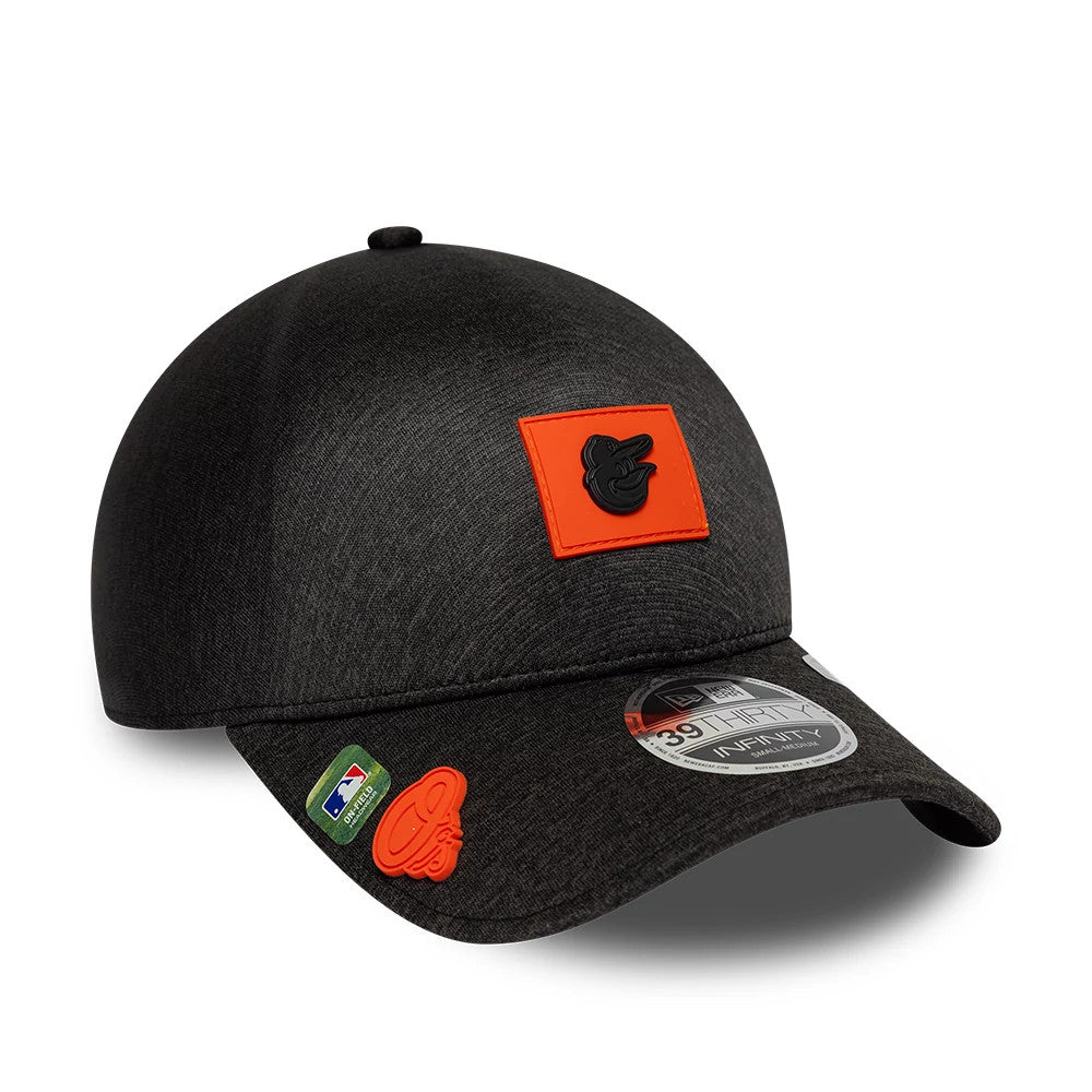 Baltimore Orioles MLB Clubhouse Black New Era 39THIRTY Infinity Stretch Fit Cap, three-quarter view showing a black-on-orange Orioles logo on the front panel, with a 39THIRTY size sticker on the black curved visor and an MLB logo patch on the side.