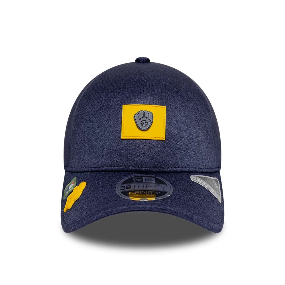 Milwaukee Brewers MLB Clubhouse Navy New Era 39THIRTY Infinity Stretch Fit Cap, front view showing the grey and yellow Brewers logo on the front panel, with a structured navy crown and multiple stickers on the curved visor.