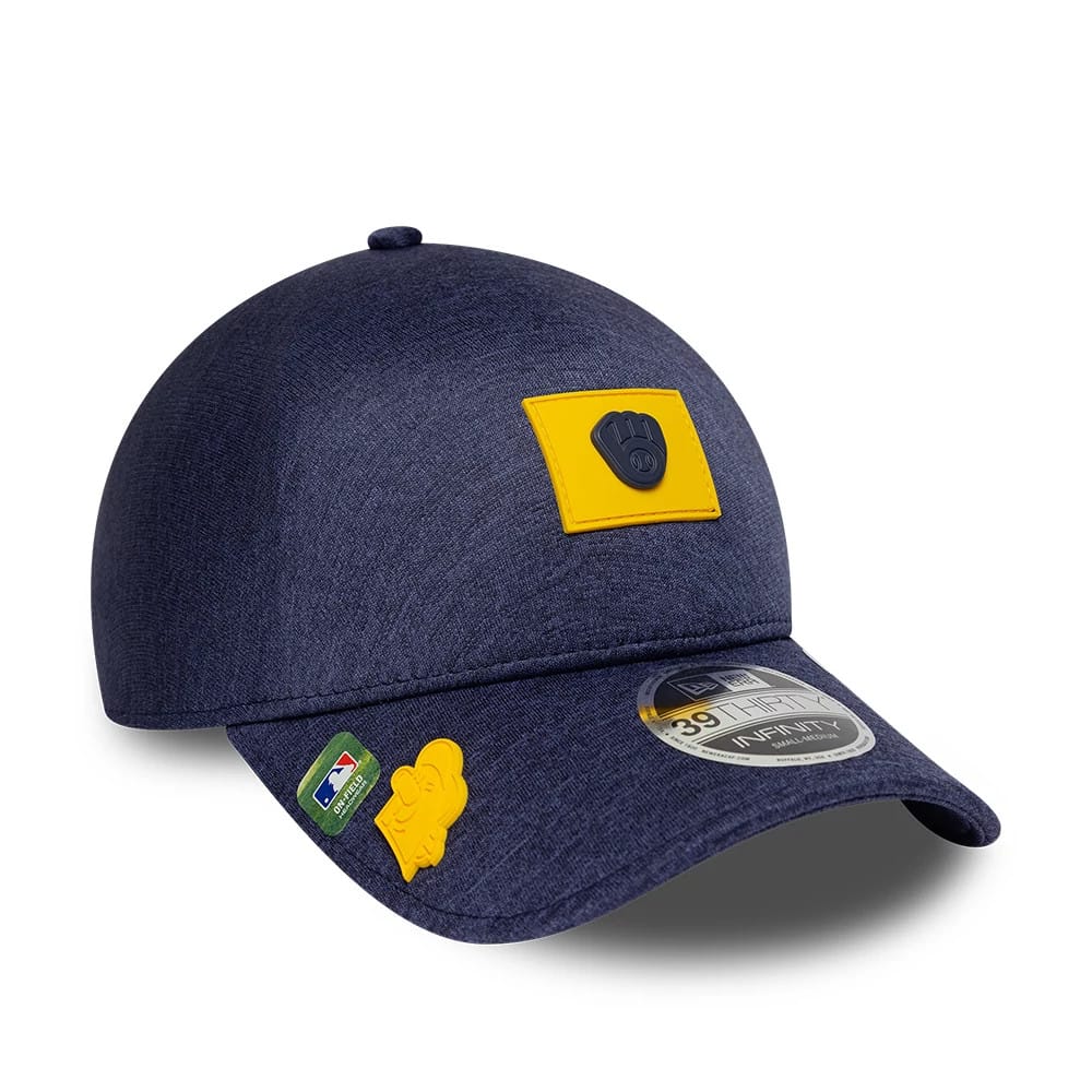 Milwaukee Brewers MLB Clubhouse Navy New Era 39THIRTY Infinity Stretch Fit Cap, three-quarter view showing a yellow patch with a navy Brewers logo on the front panel, 39THIRTY size sticker on curved visor, and decorative patches on the visor.