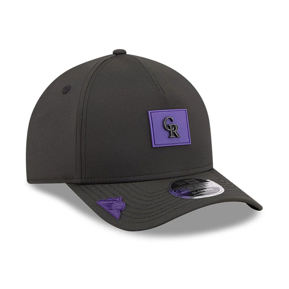Colorado Rockies MLB Clubhouse Black New Era 9FORTY M-Crown A-Frame Adjustable Cap, three-quarter view showing a purple patch with black CR logo on the front panel, curved visor with matching purple detail, and 9FORTY size sticker.